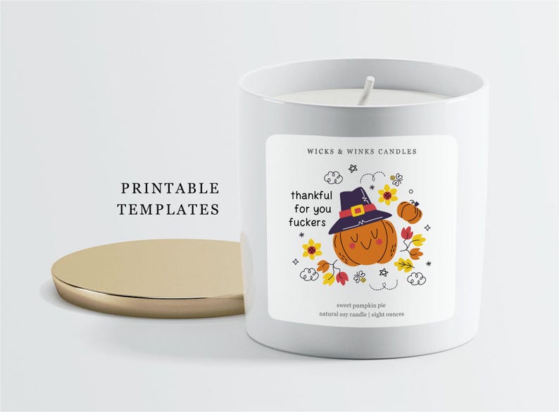 May include: A white candle with a gold lid, featuring a label with a cartoon pumpkin wearing a hat and the text "thankful for you fuckers." The candle is labeled "sweet pumpkin pie" and is 8 ounces.