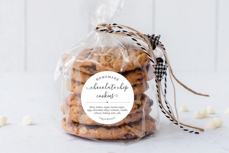 May include: A clear plastic bag filled with homemade chocolate chip cookies tied with twine and a black and white checkered bow. A white circle sticker on the bag reads "HOMEMADE chocolate chip cookies" with the ingredients listed below.