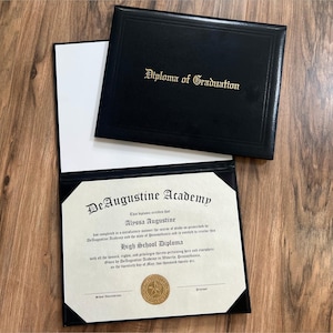 May include: Black diploma holder with gold lettering reading "Diploma of Graduation." The diploma is open, revealing a high school diploma from DeAugustine Academy. The diploma is cream-colored with black text and a gold seal.