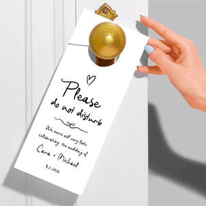 May include: White door hanger with black text that reads "Please do not disturb. We were out very late celebrating the wedding of Cara + Michael 3.2.2026".