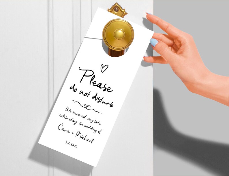 May include: White door hanger with black text that reads "Please do not disturb. We were out very late celebrating the wedding of Cara + Michael 3.2.2026".
