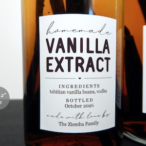 May include: A rectangular white label on an amber glass bottle containing vanilla extract. The label text reads: homemade VANILLA EXTRACT, INGREDIENTS tahitian vanilla beans, vodka, BOTTLED October 2026, made with love by The Ziemba Family. Size 3.8 x 5.1 cm.