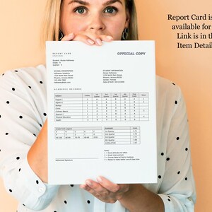 May include: A woman holds a report card with the words "OFFICIAL COPY" at the top. The report card shows a student's academic record with grades for subjects like English, Biology, and Culinary Basics. The text on the report card says "Report Card is also available for $6. Link is in the Item Details."