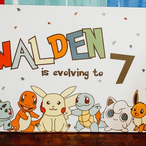 May include: A white sign with the text "Walden is evolving to 7" in colourful letters. The sign features cartoon images of Pokemon characters, including Bulbasaur, Charmander, Pikachu, Squirtle, Jigglypuff, and Eevee.