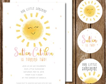May include: A yellow sun with a smiling face and closed eyes, surrounded by yellow rays, is the centrepiece of this birthday invitation. The text "Our Little Sunshine" is at the top of the invitation, and the text "Sutton Catalina is turning two!" is below the sun. The invitation also includes details about the birthday party, including the date, time, and location.