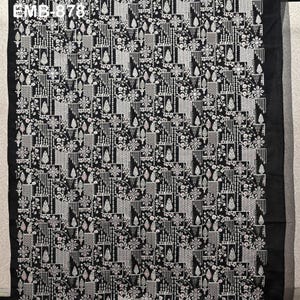May include: Black fabric with a detailed white floral and geometric pattern. The design features repeating floral and geometric shapes, creating a textured appearance. The text "EMB-878" is visible in the upper left corner.
