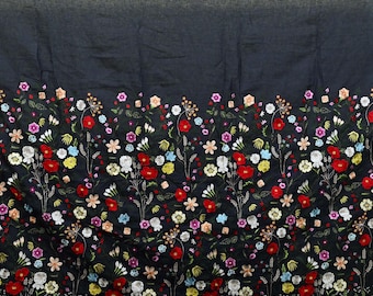 May include: Dark navy fabric with a vibrant floral embroidery border. The embroidered flowers feature red, white, pink, yellow, and blue blossoms with green leaves. The text "EMB-167" is in the upper left corner.