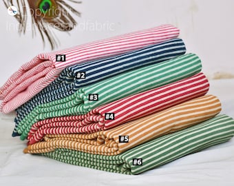 May include: Six different striped fabric swatches stacked on top of each other. The swatches are in the following order from top to bottom: pink and white, navy blue and white, green and white, red and white, orange and white, and green and white.