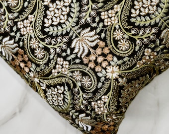 May include: Black fabric with gold and white embroidery featuring a floral pattern.