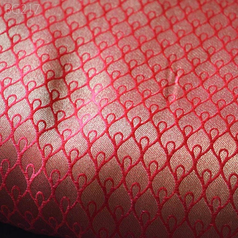 May include: Red fabric with a gold embossed pattern of interlocking loops.