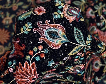 May include: Black fabric with colorful embroidered floral patterns and sequins. EMB-624.