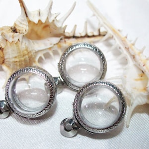 May include: Three silver locket pendants with clear glass inserts. The lockets feature an ornate design and are ideal for adding a personal touch to jewellery.