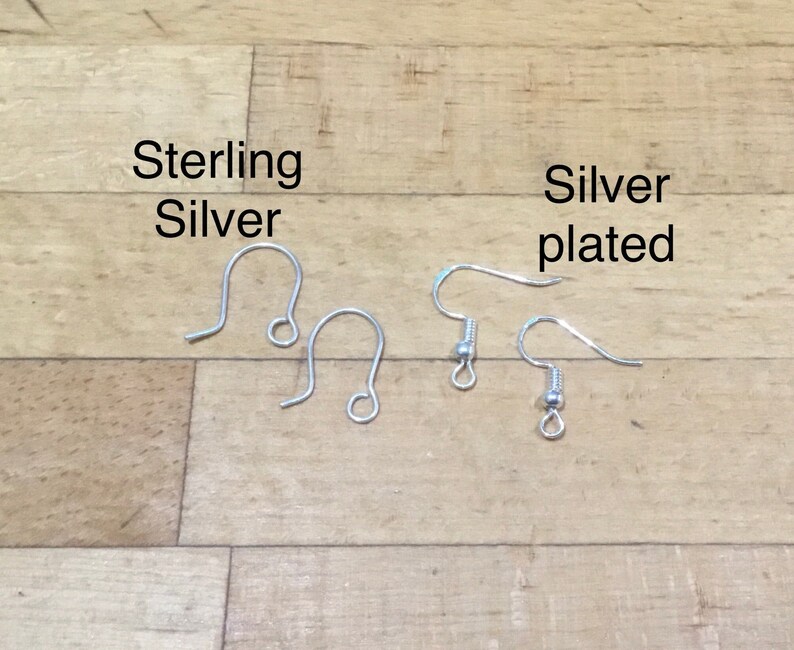 May include: Two pairs of earring hooks, one pair labeled "Sterling Silver" and the other pair labeled "Silver plated".