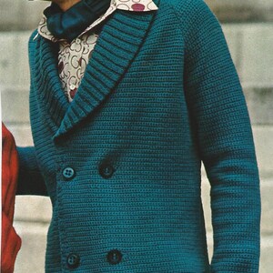 May include: A teal blue knitted cardigan with a shawl collar, four buttons, and a patch pocket. The cardigan has a textured knit pattern.
