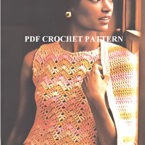 May include: A crochet top with a geometric pattern in shades of pink, yellow, and white. The top has a scalloped hem and is sleeveless.