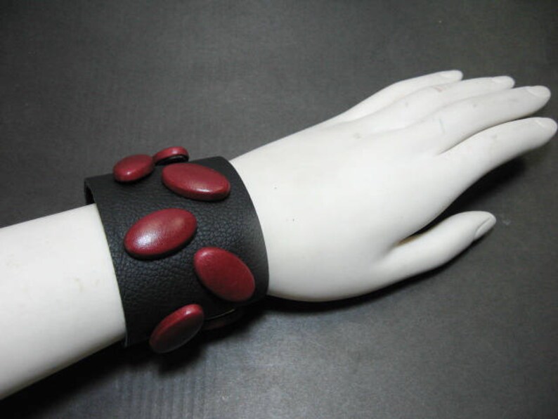 Genuine Leather Wristband with Snap Closure in Black with Red Leather Covered Buttons