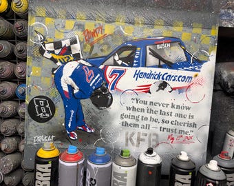 May include: A spray paint artwork on a rectangular surface featuring a race car with the number 7 and HendrickCars.com branding, a driver in a blue and white suit, a checkered flag, and the text: You never know when the last one is going to be, so cherish them all - trust me. KFB May 15th 2026.