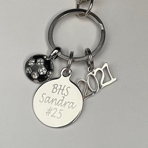 Soccer keychain personalized with Player’s name and number and school initials. Soccer ball and year charm keychain