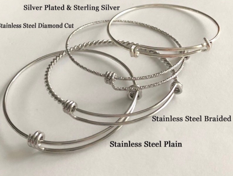 May include: Four silver bangle bracelets with different styles: silver plated and sterling silver, stainless steel diamond cut, stainless steel braided, and stainless steel plain.