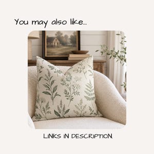 May include: A square throw cushion featuring a cream-coloured fabric base with a repeating botanical print in shades of muted green. The design displays various fern and wildflower illustrations across the surface. Text reads: You may also like... LINKS IN DESCRIPTION.