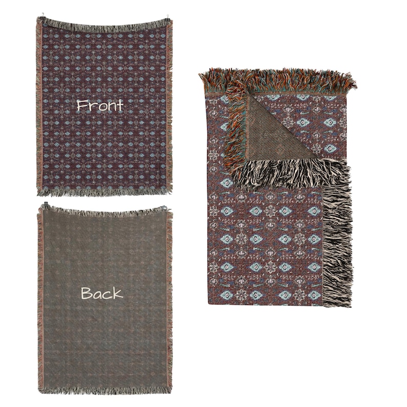 May include: Woven throw blanket with a geometric pattern in shades of burgundy, blue, and cream. The blanket has a fringed edge and the word "Front" is visible on one of the blankets. The back of the blanket is a solid brown color.