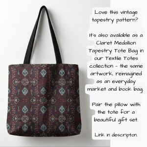 May include: A tote bag with a vintage tapestry pattern in shades of burgundy, blue, and cream. The bag has black handles and the text "Love this vintage tapestry pattern?" and "Claret Medallion Tapestry Tote Bag" on the side.