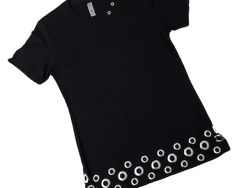 May include: Black short-sleeved t-shirt with silver grommets around the bottom hem and at the neckline.
