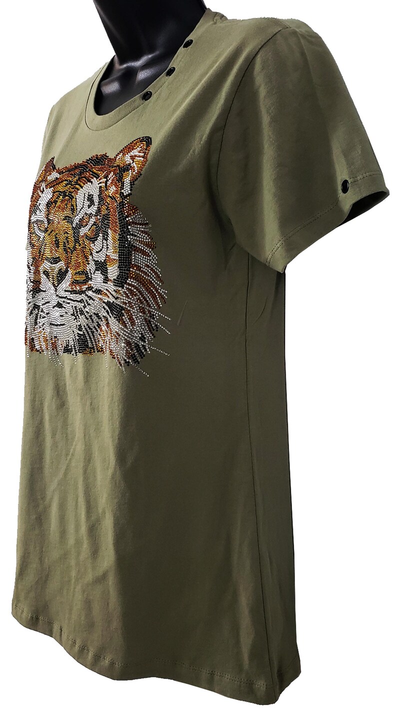 May include: A green short-sleeved t-shirt with a tiger face design made of rhinestones.