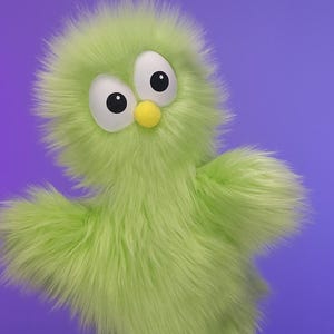 May include: A fuzzy green puppet with large white eyes and black pupils, and a yellow beak. The puppet has outstretched arms and is set against a purple background. The puppet's fur is a light green color.