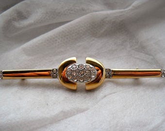 Early 90's "Ultima Edizione" vintage Brooch. Sterling Silver Gold Plated. Oval shape crossed by the bar. Logo and Maker's mark engraved.