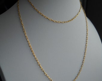 May include: A gold chain necklace with two strands of linked oval-shaped links.