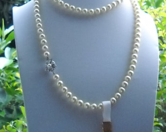 70's Mallorca pearl necklace, cream pearl, length 100 cm/39in and pearl size 0,9 cm/0.35in. Round fancy clasp with a pearl in the middle