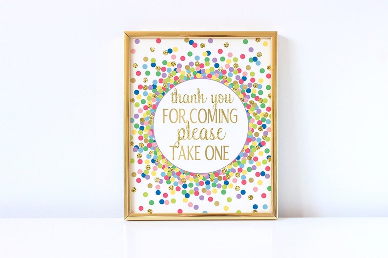 May include: A gold framed sign with a white background and colorful confetti. The sign says "thank you for coming please take one".