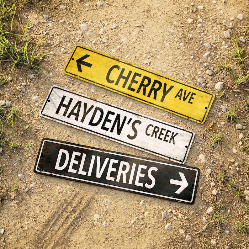 Set of three vintage style metal street signs in yellow white and black with weathered edges and custom text.