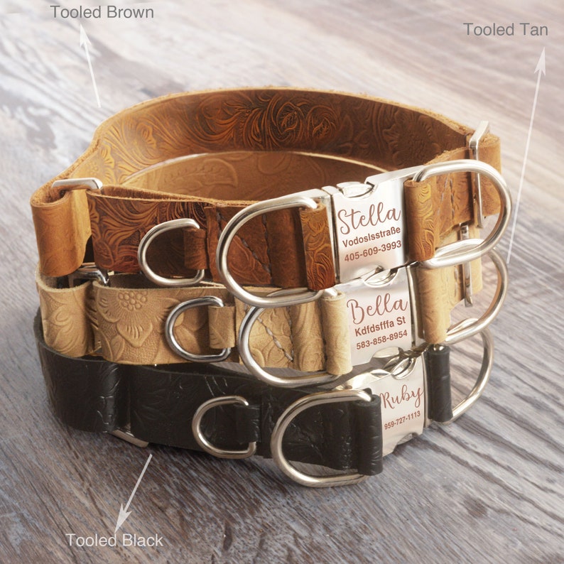 May include: Three leather dog collars in brown, tan, and black with silver buckles and engraved name tags. The collars are stacked on top of each other. The name tags read "Stella Vodosisstra&szlig;e 405-609-3993", "Bella Kdfdsfffa St 583-858-8954", and "Ruby 869-727-1113".
