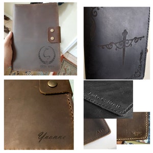 May include: Four brown leather journals with different engravings. The first journal has a snake design with the text "Zeta Rosa". The second journal has a sword design with a floral border. The third journal has the name "Yvonne" engraved. The fourth journal has the text "Luke C. Brau" engraved.