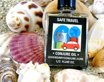 May include: A clear glass bottle with a black cap, labeled "SAFE TRAVEL + CONJURE OIL" with a graphic of a car, ship, and airplane. The bottle is surrounded by seashells on a sandy surface. The bottle contains 1/2 fluid oz.