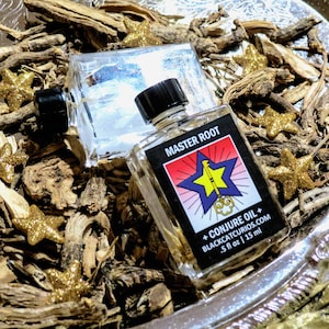 May include: Two clear glass bottles with black caps containing liquid, labeled Master Root Conjure Oil. The label features a yellow key inside a blue star on a red and white background. The text reads .5 fl oz | 15 ml and blackcatcurios.com.