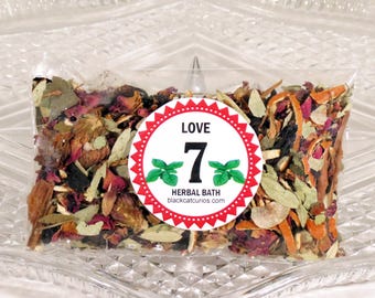 May include: A transparent bag containing dried herbs and flowers. A circular sticker with the words "LOVE 7 HERBAL BATH" and a website address is on the front. The bag rests on a clear, patterned glass dish.