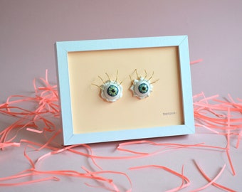 Frame with a porcelain eyes,  Porcelain sculpture on a picture or canvas, Painting and illustration for home decoration