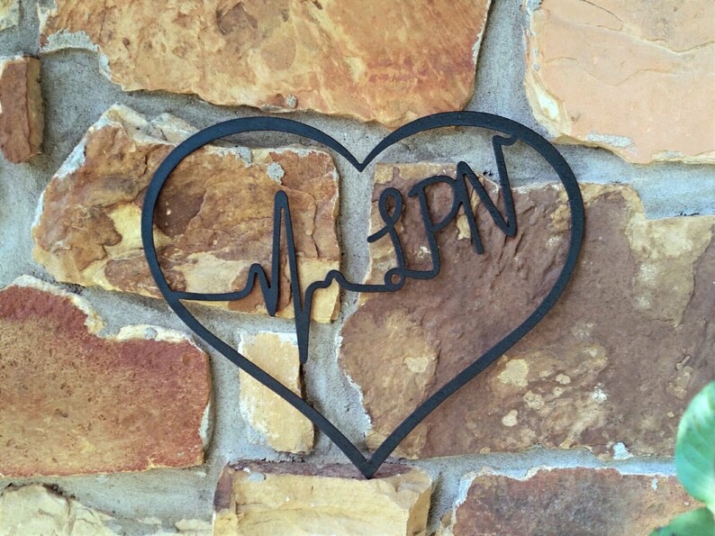 May include: Black metal heart-shaped wall decor with a stylised EKG line and the word "LPN" inside.