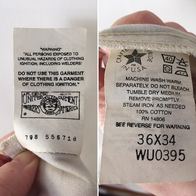 May include: Close-up of two clothing tags. One tag has a warning about clothing ignition and the United Garment Workers of America logo. The other tag has washing instructions, the text "Crafted in USA", and the size 36x34.
