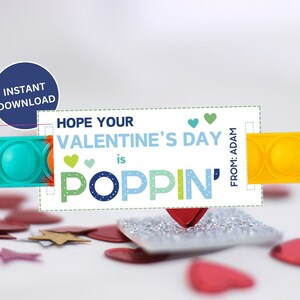 May include: A Valentine's Day card with a teal and yellow pop-it toy. The card reads "Hope Your Valentine's Day is Poppin'" with a blue circle that says "Instant Download". Red heart confetti is scattered around the card.