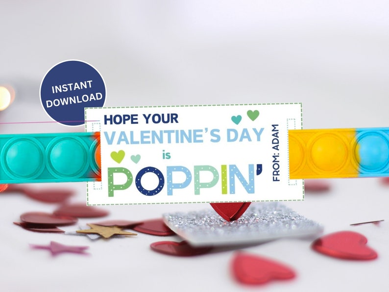 May include: A Valentine's Day card with a teal and yellow pop-it toy. The card reads "Hope Your Valentine's Day is Poppin'" with a blue circle that says "Instant Download". Red heart confetti is scattered around the card.