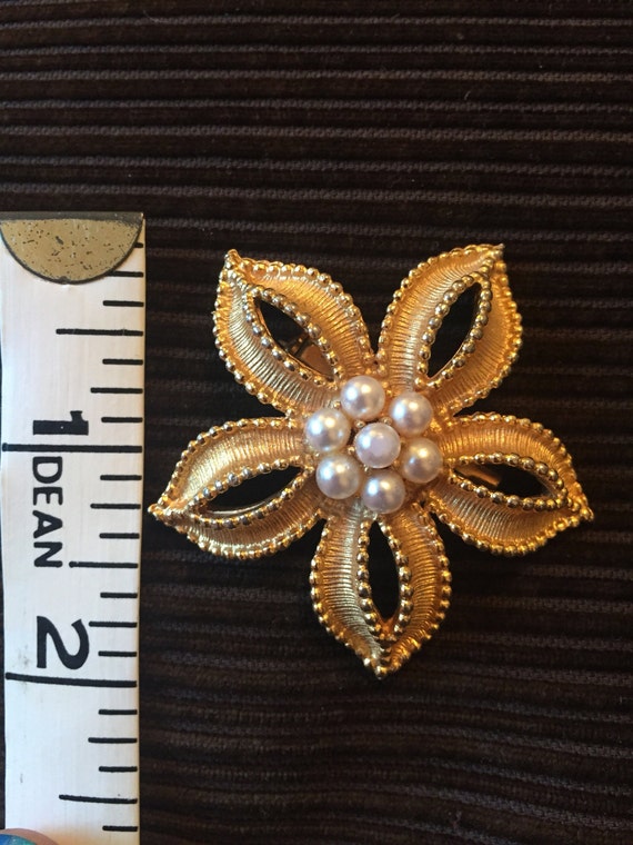 Gold metal flower brooch with pearls