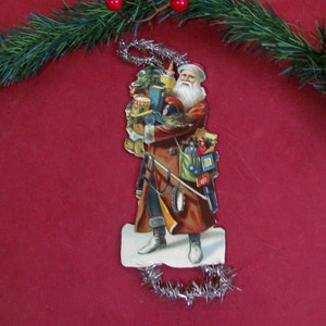 Antique Christmas Ornament Santa Claus Feather Tree Victorian Die-Cut Santa Claus Brown Robe & Toys Silver Tinsel Hanger Antique Christmas