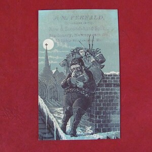 Cartão comercial antigo Papai Noel lendo um livro apoiado em uma chaminé J. M. Fernald Livros Efêmeros de propaganda antiga