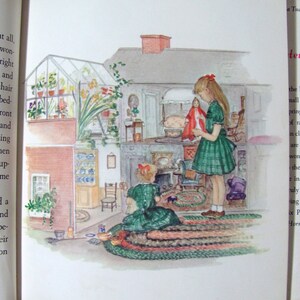 May include: Two girls play in a dollhouse with a green rug, a fireplace, and a doll bed. The dollhouse has a greenhouse on the roof.
