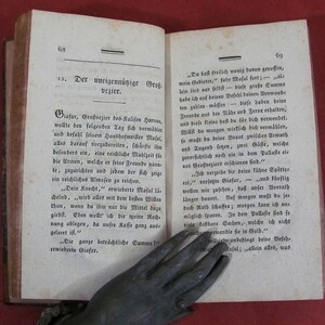 May include: An open antique book with aged, off-white pages featuring black printed German text. The left page is numbered 68 and titled 12. Der uneigenn&uuml;tzige Gro&szlig;vezier. The right page is numbered 69. The paper shows signs of age with light discoloration.