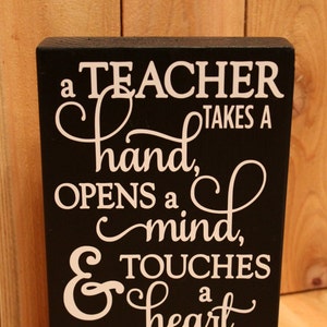 A teacher takes a hand, opens a mind, and touches a heart small wood block with vinyl / Teacher Gift / Classroom decor / Wood decor / Gift image 1